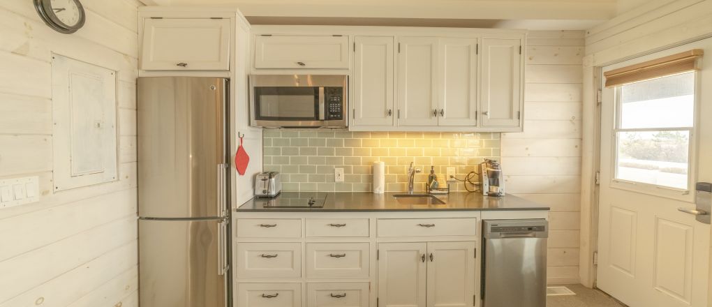 A Kitchen With White Cabinets